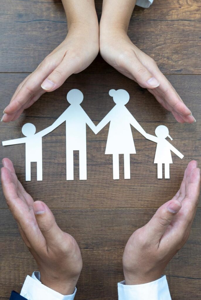 hands over paper cut out of family